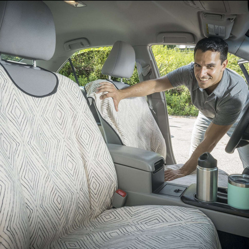 Man Placing Boho Dot Car Seat Covers on Front Seats From SeatSpin